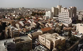 Aerial view of central Jerusalem showing dense mid-rise neighborhoods near the Mahane Yehuda district.