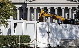 Construction equipment behind fencing at the White House East Wing site.