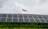 WEB Pitt Airport Solar.jpg Photo shows an airplane flying over a solar array at the Pittsburgh International Airport