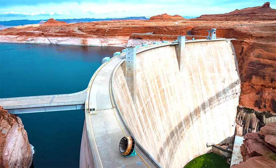 Glen Canyon Dam with low Lake Powell water levels visible upstream.