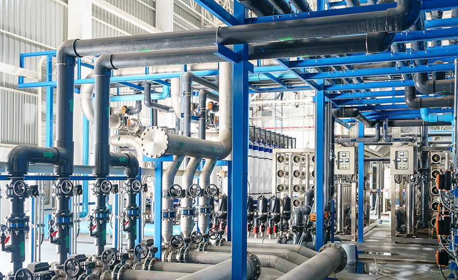Interior view of a large municipal water treatment facility, showing extensive piping, valves and filtration equipment arranged in an industrial setting.