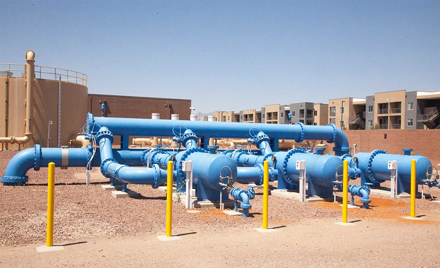 Aerial view of municipal water treatment and conveyance infrastructure serving mixed urban and rural communities.