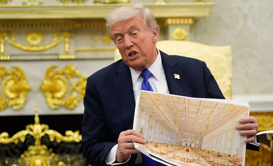 President Donald Trump holds an artist rendering of interior of the new White House ballroom.