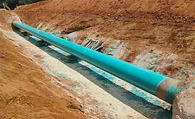 Pipeline segment installed in an open trench during construction work.