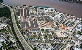 Aerial view of DC Water’s Blue Plains wastewater treatment plant with circular clarifier basins along the Potomac River.