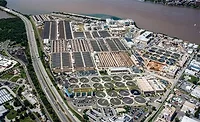 ICE-Detention-and-Sewer-Capacity Aerial view of DC Water’s Blue Plains wastewater treatment plant with circular clarifier basins along the Potomac River.