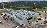 ABC. Feb. 27 Report.jpg Aerial view of a semiconductor manufacturing facility under construction with cranes and structural steel framing visible.