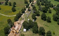 STV-Job-Central-Texas Aerial view of construction crews installing large water transmission pipeline segments along a rural corridor in Central Texas.