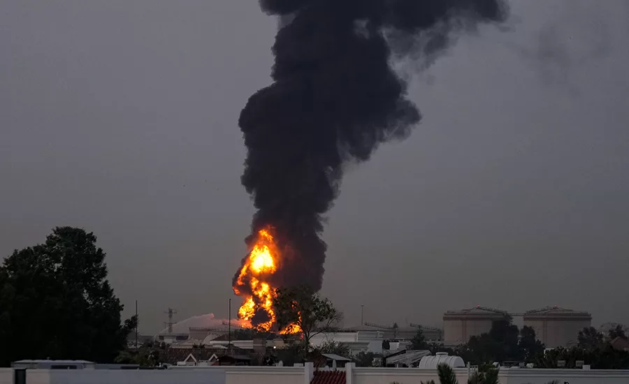 Fire and smoke rise after a drone hit a fuel tank near Dubai International Airport, causing a temporary flight suspension on Monday, March 16, 2026.