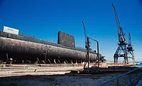 Navy-Fraud Submarine under construction with cranes and industrial infrastructure