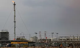 Ras Laffan LNG facility showing pipelines, processing units and a flare stack.