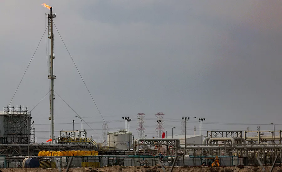 Ras Laffan LNG facility showing pipelines, processing units and a flare stack.