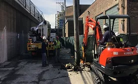 CTA construction crew with excavator performing utility work in Chicago corridor
