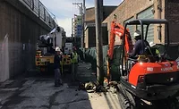 CTA construction crew with excavator performing utility work in Chicago corridor