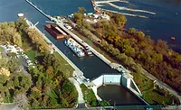 Brandon-Road-Lock-and-Dam Aerial view of Brandon Road Lock and Dam in Joliet, Illinois, with barge traffic in the channel.