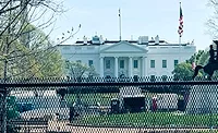 White House seen from Lafayette Square with fencing and visible construction activity on the grounds in Washington, D.C.