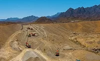 Excavators perform earthworks along the Oman–UAE Hafeet Rail route in mountainous terrain.