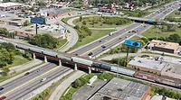 Aerial view of freight train crossing a bridge over a busy Chicago highway corridor
