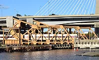 MBTA commuter train crossing the Draw One rail bridge over the Charles River in Boston.