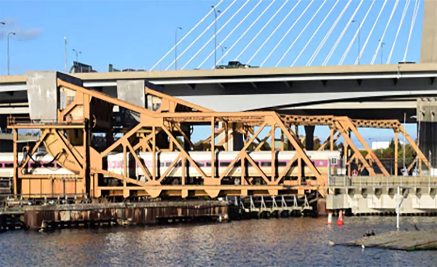 MBTA commuter train crossing the Draw One rail bridge over the Charles River in Boston.