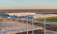 March 2026 Construction Spending Electrical infrastructure and data center construction site in Hutto, Texas. data center under construction beside electrical transmission infrastructure.