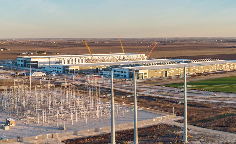 Electrical infrastructure and data center construction site in Hutto, Texas. data center under construction beside electrical transmission infrastructure.