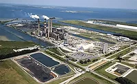 Aerial view of a coal-fired power plant with water-management infrastructure.