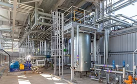 Process piping and industrial systems inside a pharmaceutical manufacturing facility.