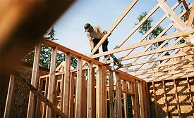 A worker frames a single-family home. Berkshire Hathaway's planned acquisition of Taylor Morrison comes as economists point to early signs that construction activity may be spreading beyond data center-related projects.