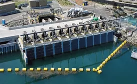 Aerial view of the Carlsbad Desalination Plant intake and discharge facility in California with water intake equipment and engineered shoreline infrastructure.