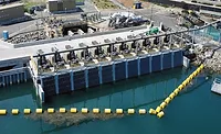 Aerial view of the Carlsbad Desalination Plant intake and discharge facility in California with water intake equipment and engineered shoreline infrastructure.