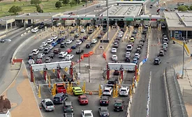 Aerial view of the Bridge of the Americas port of entry in El Paso, Texas, showing multiple vehicle inspection lanes and non-intrusive inspection scanning portals handling cross-border traffic.