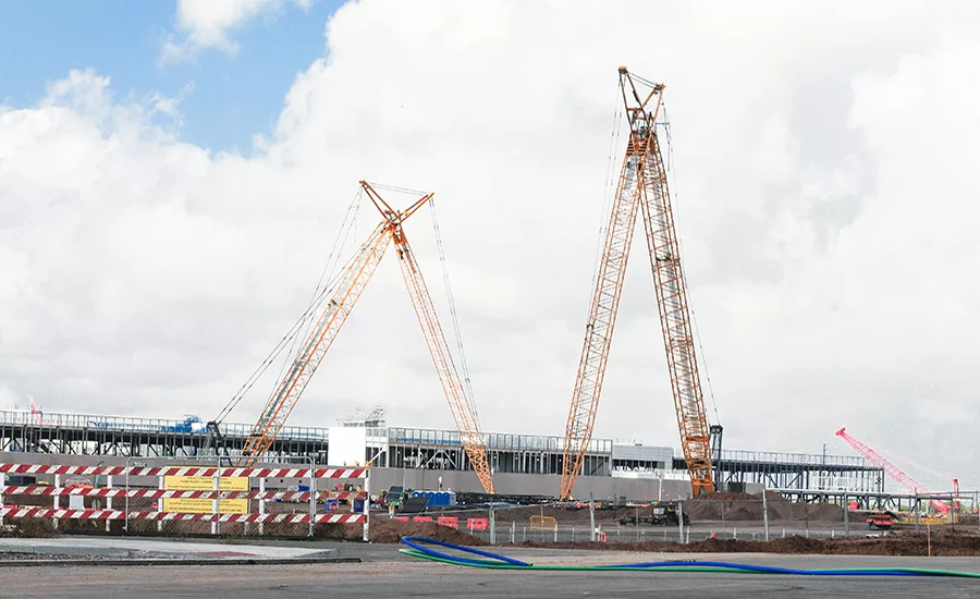 Large cranes tower over a hyperscale data center campus as construction continues on additional buildings at Meta's Mesa, Ariz., facility.