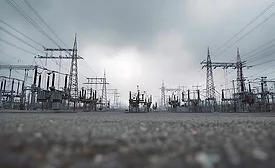 High-voltage transmission substation and power lines on the electric grid.