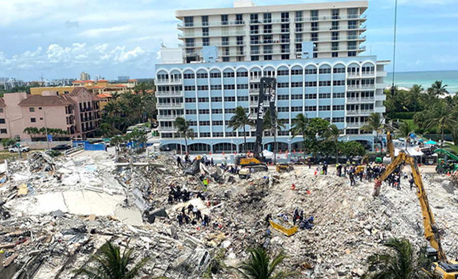 Aerial view of the collapsed Champlain Towers South condominium in Surfside, Fla., with rescue crews and heavy equipment working amid the rubble.