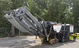 Wirtgen W 220 XF cold milling machine displayed during a John Deere roadbuilding technology demonstration near Nashville, Tennessee.