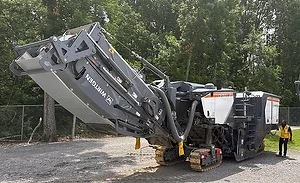 Wirtgen W 220 XF cold milling machine displayed during a John Deere roadbuilding technology demonstration near Nashville, Tennessee.