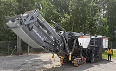 Wirtgen W 220 XF cold milling machine displayed during a John Deere roadbuilding technology demonstration near Nashville, Tennessee.