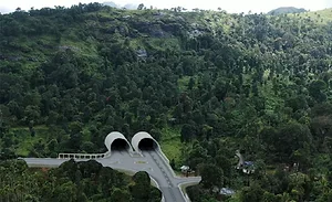 India-Tunnel-Rendering Concept rendering of the twin portals for the Anakkampoyil-Kalladi-Meppadi highway tunnel project in Kerala, India, set into a forested mountainside.