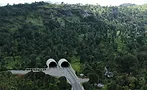 Concept rendering of the twin portals for the Anakkampoyil-Kalladi-Meppadi highway tunnel project in Kerala, India, set into a forested mountainside.