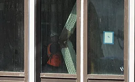 Worker inspects a buckled structural member inside the former Pfizer headquarters conversion in Midtown Manhattan.