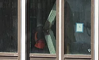 Worker inspects a buckled structural member inside the former Pfizer headquarters conversion in Midtown Manhattan.