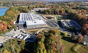Aerial view of DataBank's LGA3 data center campus in Orangeburg, N.Y., with electrical infrastructure and surrounding wooded landscape.