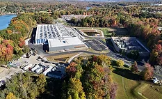 Aerial view of DataBank's LGA3 data center campus in Orangeburg, N.Y., with electrical infrastructure and surrounding wooded landscape.