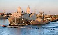 U.S. Navy ships moored at a naval base.