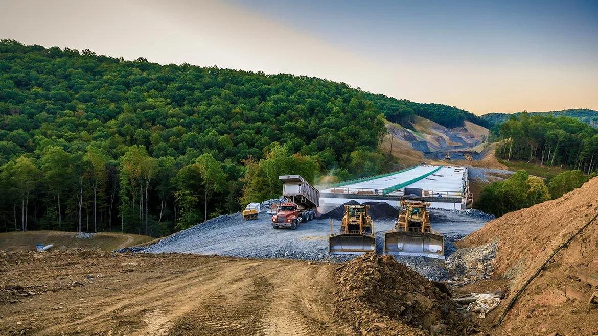 The photo shows a bridge under construction in West Virginia. WVDOT is the ENR MidAtlantic Owner of the Year