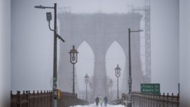 Pedestrians crossed the Brooklyn Bridge during a snowstorm on Jan. 29, 2022