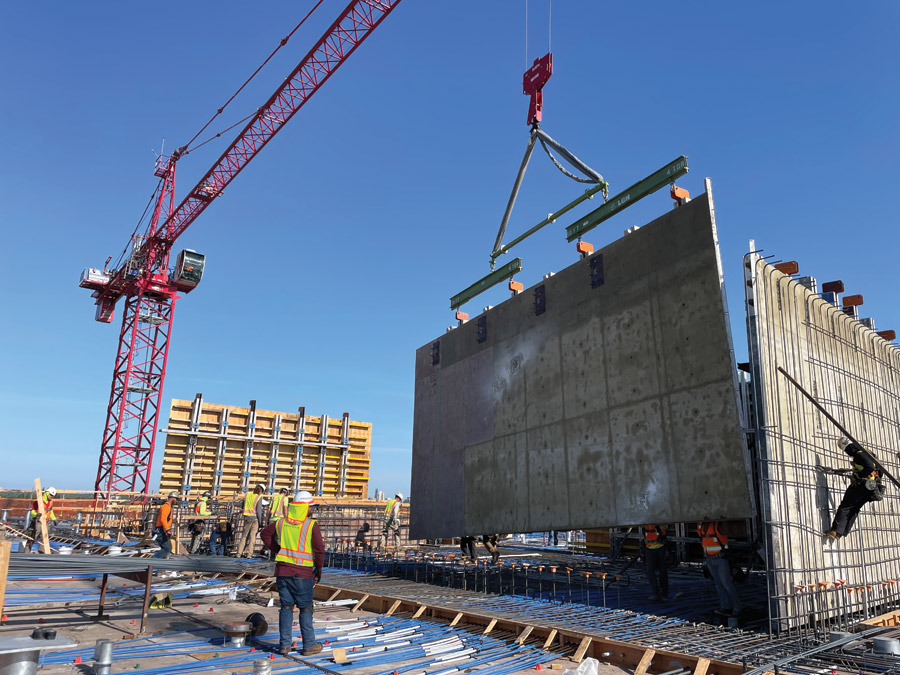 Crews place a concrete panel