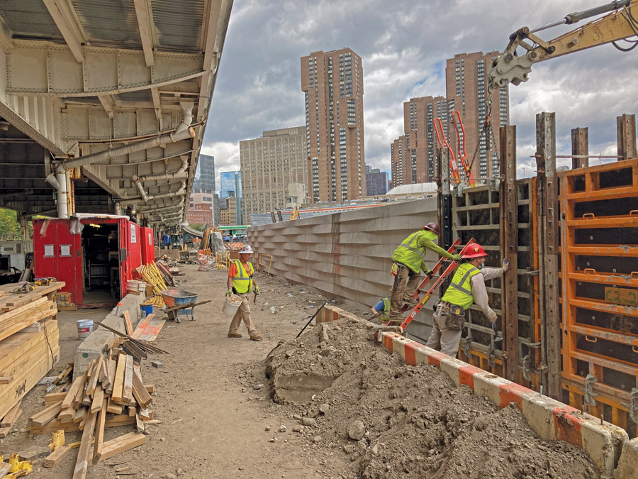 Workers remove concrete forms