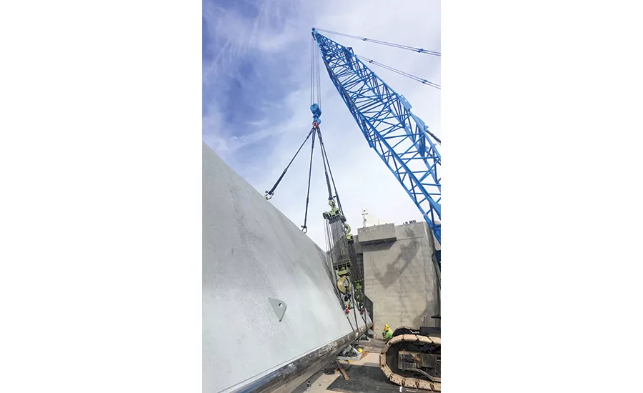 Crews lift one of the gates